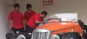 Two men standing next to car
