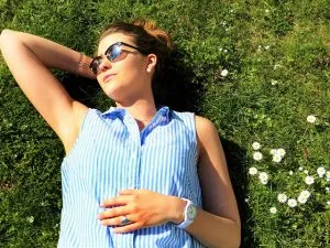 Woman laying on the grass and enjoying the perks of moving to a warmer climate.