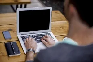A man working on a laptop.