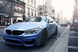 A blue car on the street.