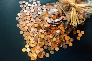 Coins spilling out of a jar.