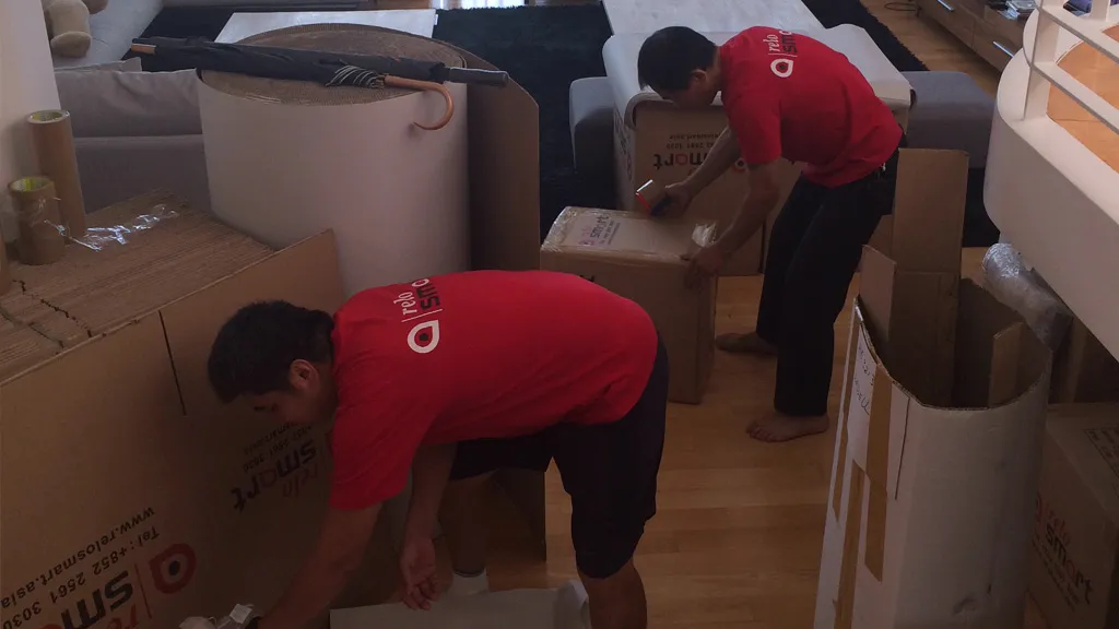 ReloSmart movers packing cardboard boxes and offering moving service Hong Kong