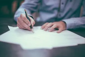 A man signing documents.
