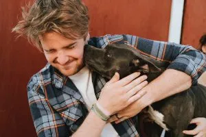 man hugging a dog