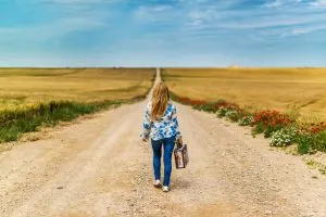 woman with a suitcase-the road