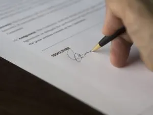 Man signing a contract.