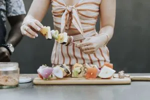Woman making food - Food is not crucial for a good housewarming party.