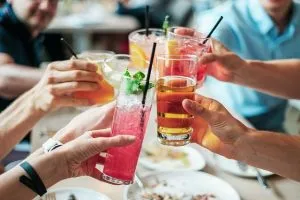 People clinking glasses - Throw a great housewarming party in Hong Kong and set up a bar in your home