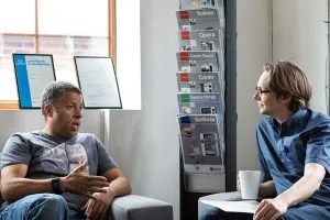 Two men talking in an office.