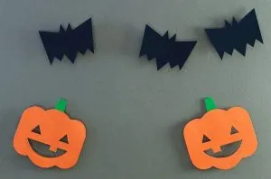 Three paper bats and two paper pumpkins.