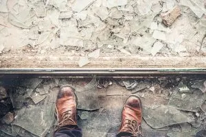 Man standing in broken glass.