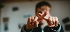 a child crossing his fingers