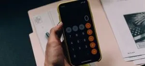 a hand holding a calculator