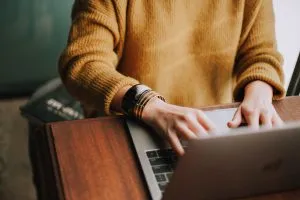 A woman typing on a laptop