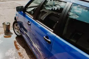 A bucket of water in front of the car