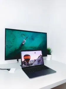 A PC monitor and a laptop on a desk