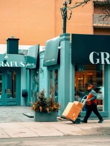 -man pushing a hand truck wit boxes
