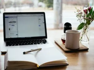 A notebook, a pen and a laptop