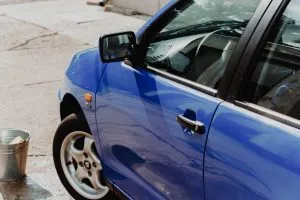 A bucket of water in front of a car