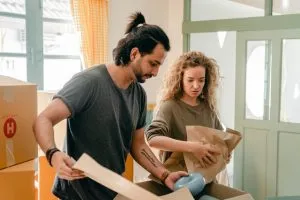 Two people packing for moving in bad weather