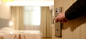 Person opening to door to a furnished room after shipping furniture to Hong Kong on time.