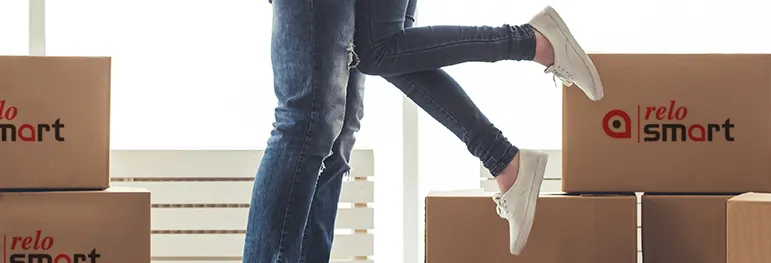 Two people hugging and moving boxes