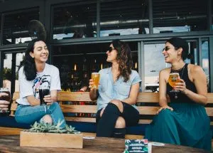 three females talking laughing