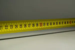 Picture of a measuring tape. Measure everything twice before you rearrange your furniture after moving