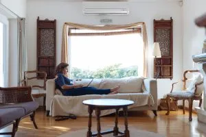 Picture of a woman reading a book on a couch