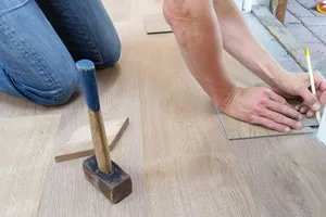 Person measuring wooden floor