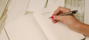A pen in hand and a planner