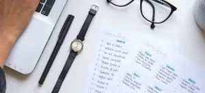 Planner, laptop, glasses and a watch