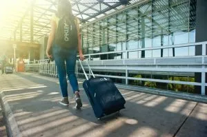 A woman is traveling carrying her luggage