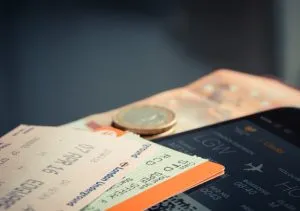 Two flight tickets are on top of a smart phone.