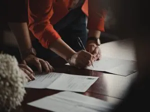 people signing papers