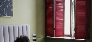 Woman is lying on bed and reading a book in a hotel room