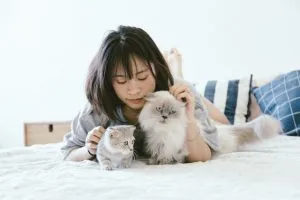 a woman with two cats