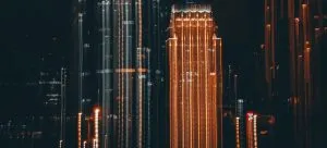 A tall, modern building in Hong Kong during night
