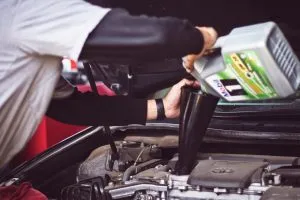 person changing the oil
