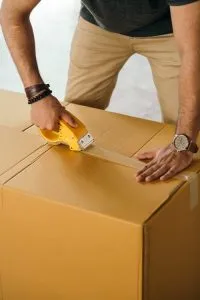 a man sealing a box