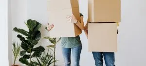couple carrying moving boxes