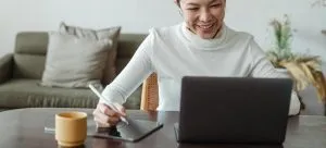 a woman writing on her ipad