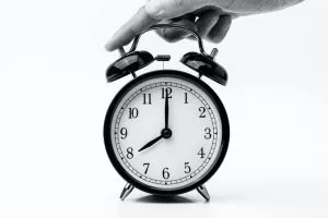 a man touching the clock - move a home office in a week
