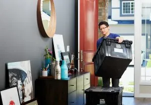 person using a box for minimalist packing and moving