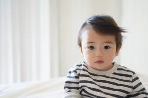 a child looking at the camera - move to a bigger house