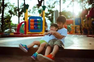two boys hugging