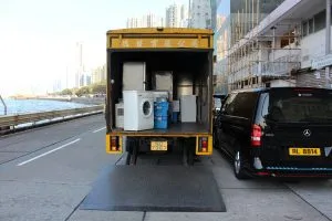 movers pack a truck that is open