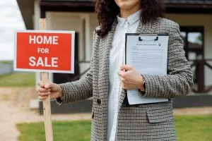 a woman holding a sign