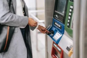 faceless woman buying a ticket