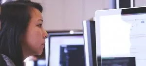 a woman looking at the computer screen, maybe googling how to find movers for your overseas relocation